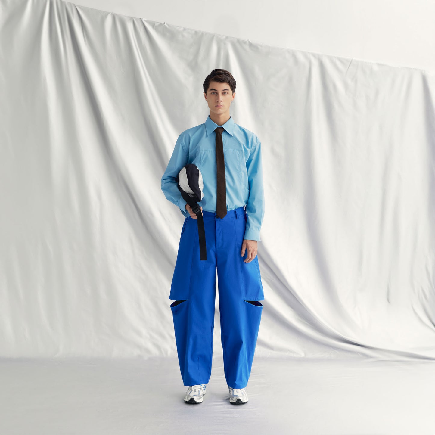 DANS SHIRT | BLUE with lapel collar, buttoned cuffs, front button closure, and distinctive layered design.
