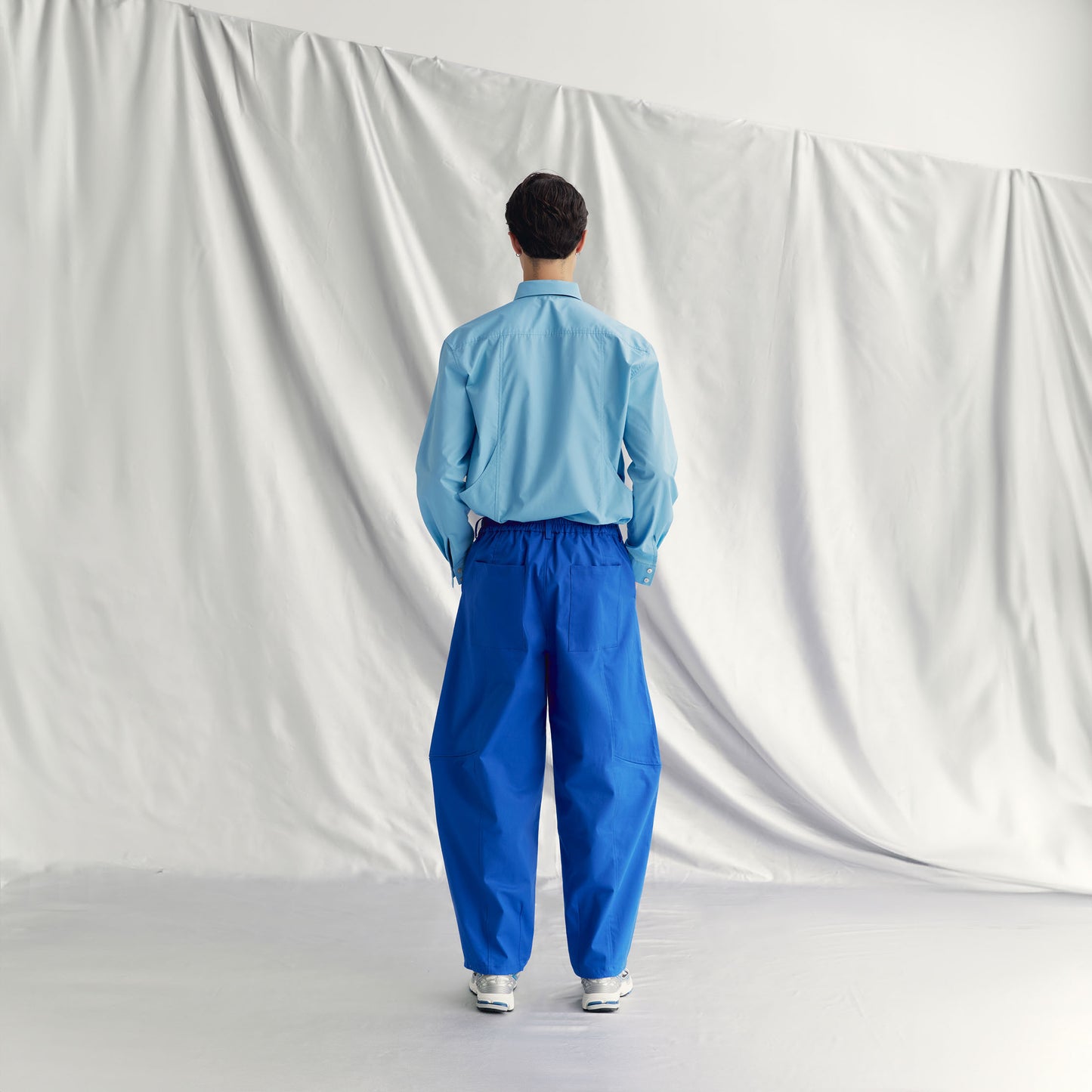 JAKOB PANTS | BLUE made from khaki cotton with an elasticated waistband and knee zippers for adjustable styling.
